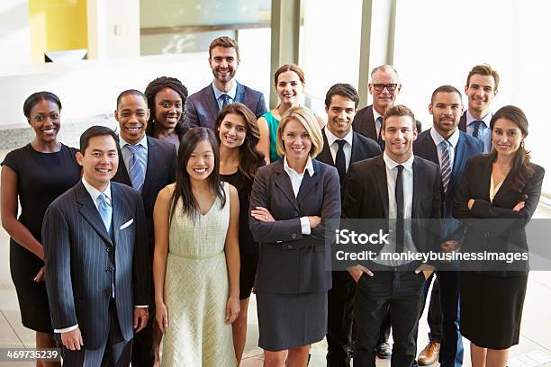 Multicultural Office Staff Standing In Lobby Stock Photo - Download Image Now - Multiracial Group, Group Of People, Large Group Of People