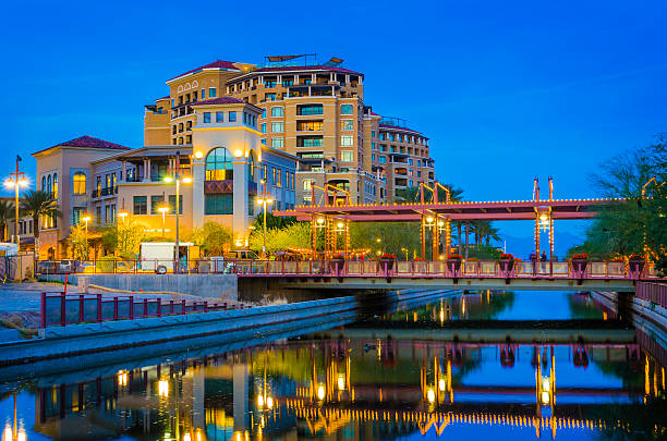 Scottsdale at dusk A scene from Downtown Scottsdale at dusk with a canal and reflections in the foreground.  Scottsdale is part of the Phoenix Metropolitan area. scottsdale arizona stock pictures, royalty-free photos & images
