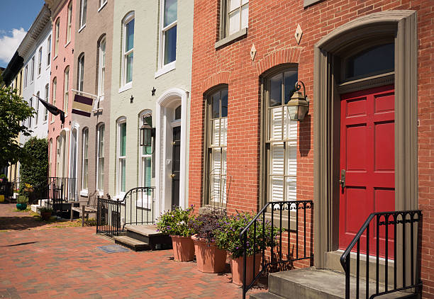 Row of brick houses on a residential street in Baltimore, MD Row houses on residential street in Baltimore, MD baltimore maryland stock pictures, royalty-free photos & images