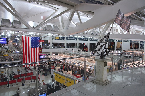 New York, USA - June 7, 2013: People hurry at JFK Airport on June 7, 2013 in New York. In 2012, the airport handled 49.3 million passengers (6th busiest in the United States).