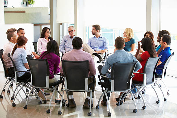 istock Multi-Cultural Office Staff Sitting Having Meeting Together 469737767