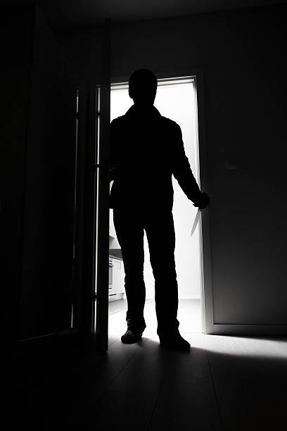 istock Full-length of thief breaking into house 469738021