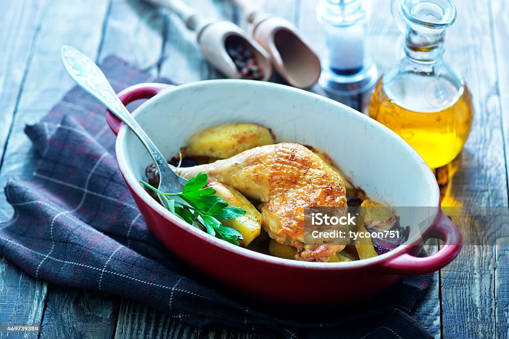 fried chicken leg fried chicken leg and baked potato in bowl and on a table 2015 Stock Photo