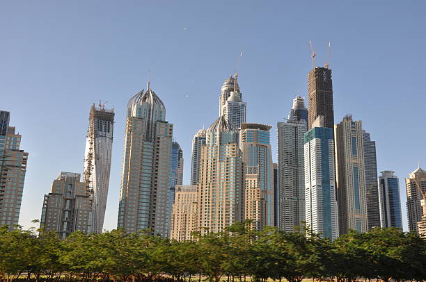 Dubai, UAE - December 22, 2011: Sheikh Zayed Road skyscrapers in Dubai, UAE. The Sheikh Zayed Road (E11 highway) is home to most of Dubai's skyscrapers, including the Emirates Towers.