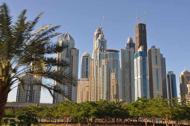Dubai, UAE - December 22, 2011: Sheikh Zayed Road skyscrapers in Dubai, UAE. The Sheikh Zayed Road (E11 highway) is home to most of Dubai's skyscrapers, including the Emirates Towers.