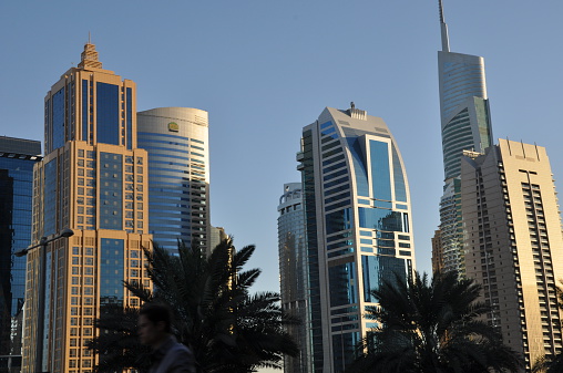 Dubai, UAE - December 22, 2011: Sheikh Zayed Road skyscrapers in Dubai, UAE. The Sheikh Zayed Road (E11 highway) is home to most of Dubai's skyscrapers, including the Emirates Towers.