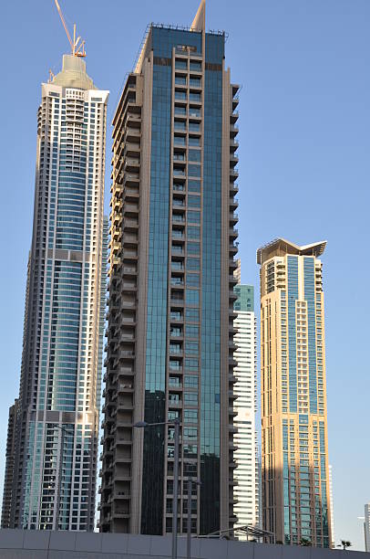 Dubai, UAE - December 22, 2011: Sheikh Zayed Road skyscrapers in Dubai, UAE. The Sheikh Zayed Road (E11 highway) is home to most of Dubai's skyscrapers, including the Emirates Towers.