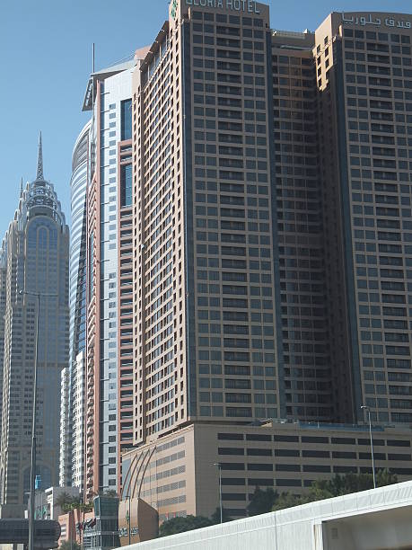 Dubai, UAE - December 21, 2011: Sheikh Zayed Road skyscrapers in Dubai, UAE. The Sheikh Zayed Road (E11 highway) is home to most of Dubai's skyscrapers, including the Emirates Towers.