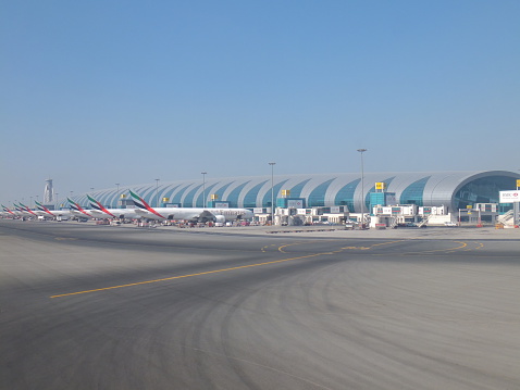 Dubai, UAE - December 17, 2011: Emirates Airlines planes at Dubai International Airport in the UAE. It is a major airline hub in the Middle East, and is the main airport of Dubai.