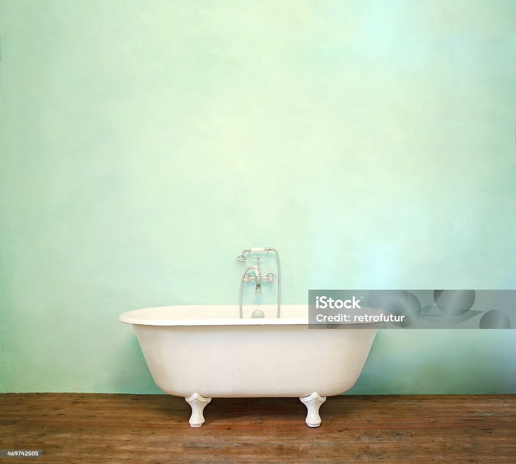 Vintage Bath French vintage bathroom with a parquet and blue wall Bathtub Stock Photo