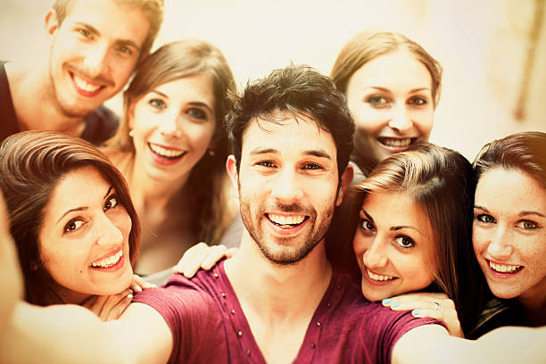 istock Group of students taking selfie outdoors 469743586