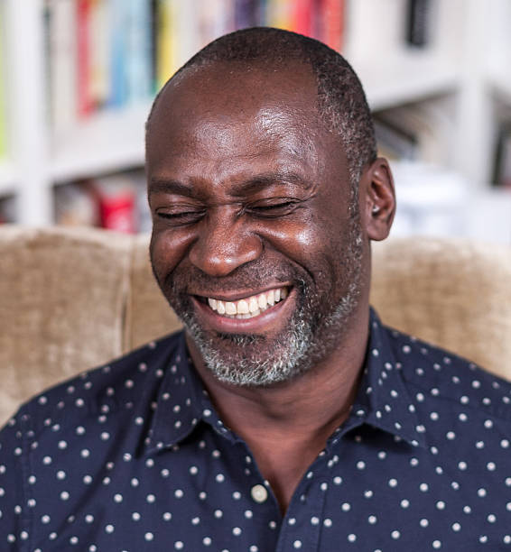istock African american man with contagious laughter sitting 469750168