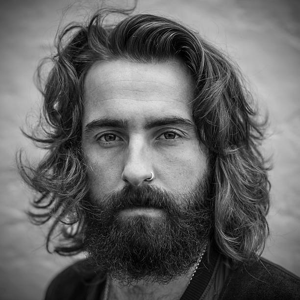 istock Serious looking young man with beard black & white portrait 469750174