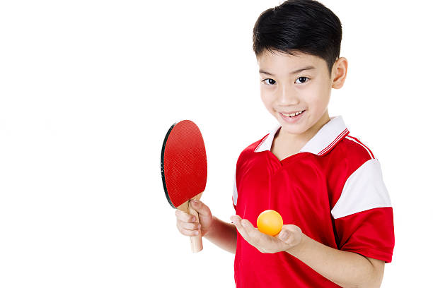 Portrait of Happy asian boy play table tennis stock photo