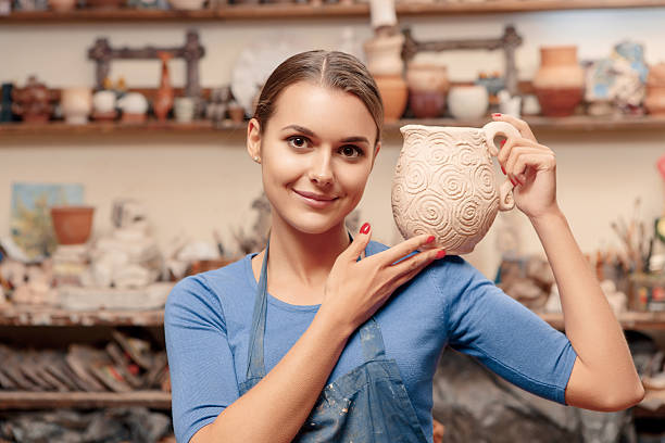istock Girl holds a clay jar 469750528