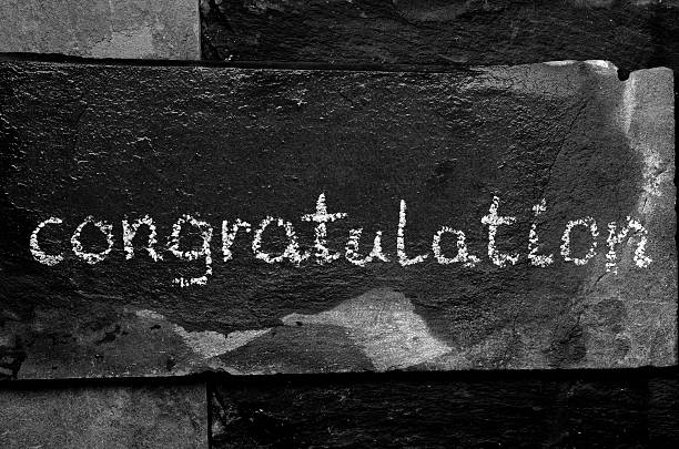 istock The word CONGRATULATION written with chalk on black stone. 469750904