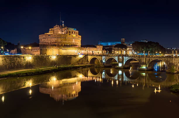 Beautiful night view of Saint Angel Castle and bridge over the Tiber river in Rome, Italy