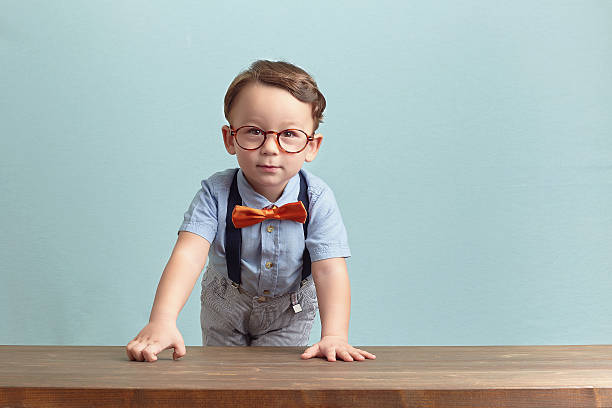 istock Sad little boy in an orange bow tie and glasses 469753462