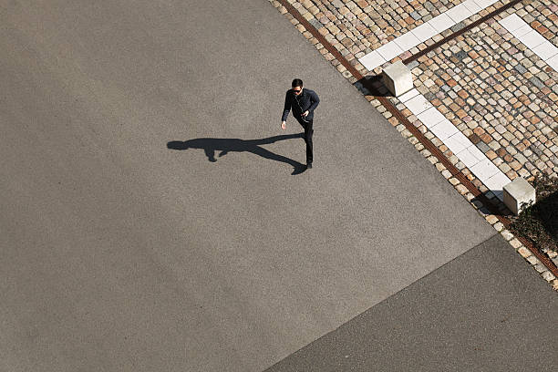 istock Young man walking ahead in a sunny day 469753728