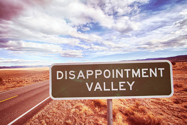istock Road Sign Reading DIsappointment Valley 469754198
