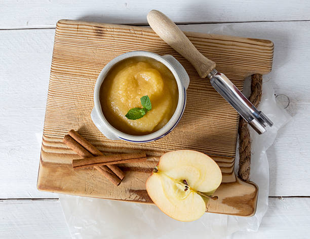 Applesauce with cinnamon in stoneware bowl Applesauce with cinnamon in stoneware bowl. compote photos stock pictures, royalty-free photos & images