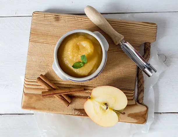 Applesauce with cinnamon in stoneware bowl.