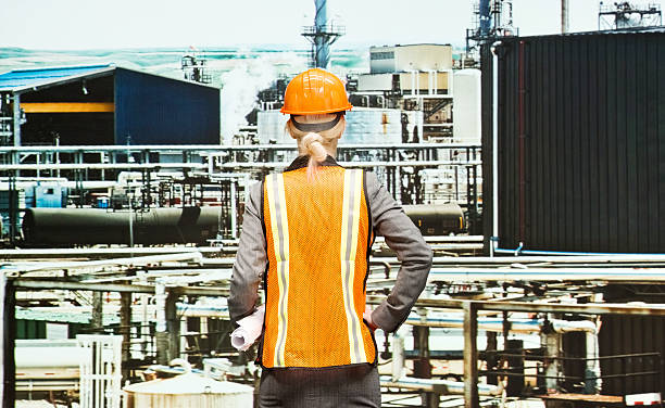 istock Rear view of female architect in refinery 469757176