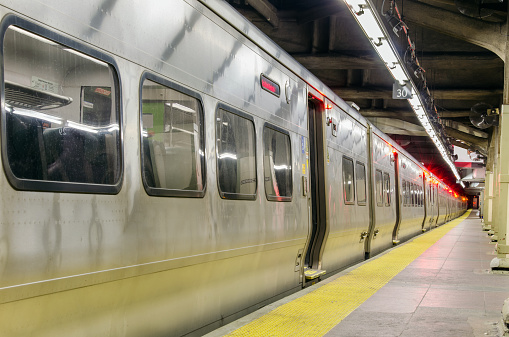 New York City subway train departing from a station.