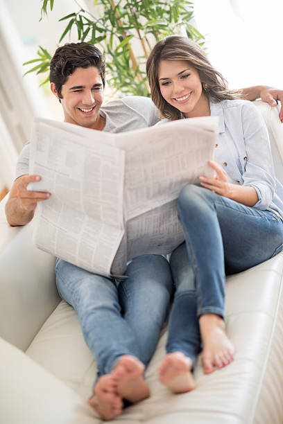 istock Couple reading the newspaper at home 469758000