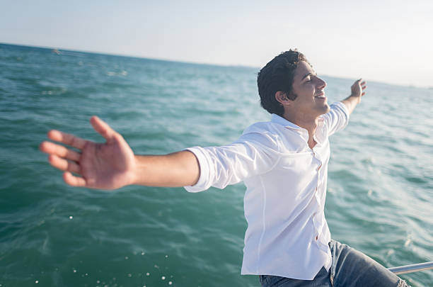 istock Happy man sailing in a boat 469758088