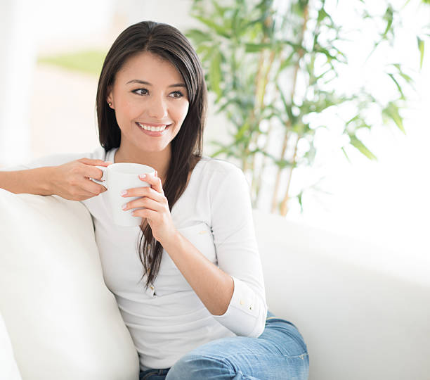 istock Woman drinking coffee at home 469758170