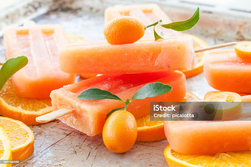 Homemade orange popsicles Homemade frozen popsicles made with oragnic fresh oranges 2015 Stock Photo
