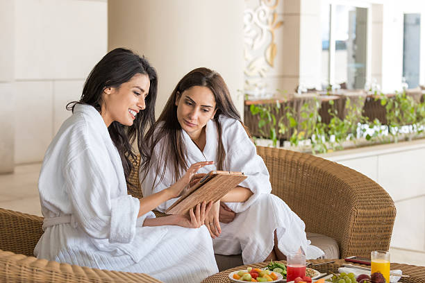 Middle Eastern Women with Computer Tablet Having Spa Meal Together
