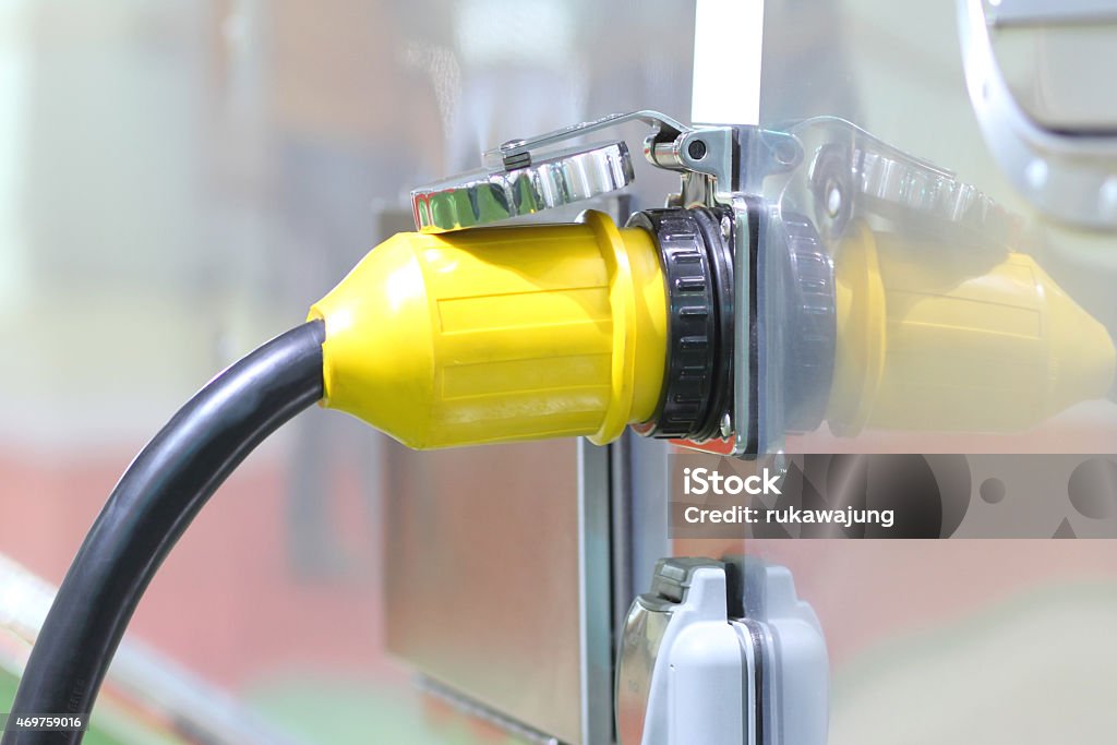 High voltage Plugs Yellow High voltage Plugs in Chargers time. 2015 Stock Photo