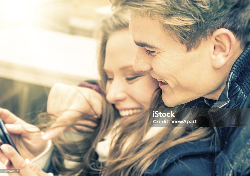 Couple in love having fun with a Smartphone Adult Stock Photo
