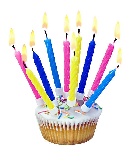 istock Birthday cupcake with burning candles 469760513