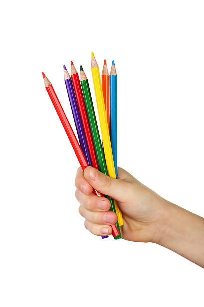istock Colorful pencils in child hand on white background 469762330