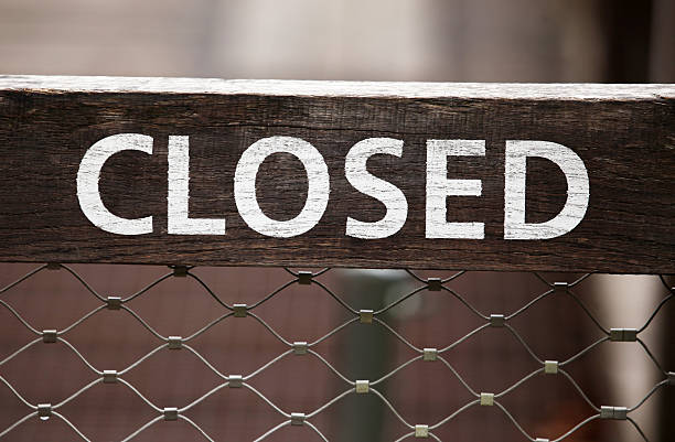 This is a wooden sign CLOSED.