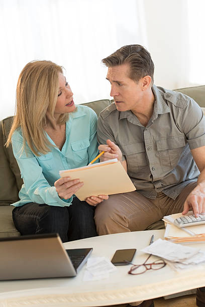 istock Mature couple calculating home finances on sofa 469764632