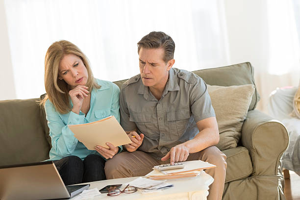 istock Mature couple calculating home finances on sofa 469764634