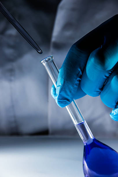 istock laboratory flask with blue liquid and volumetric pipette 469767383