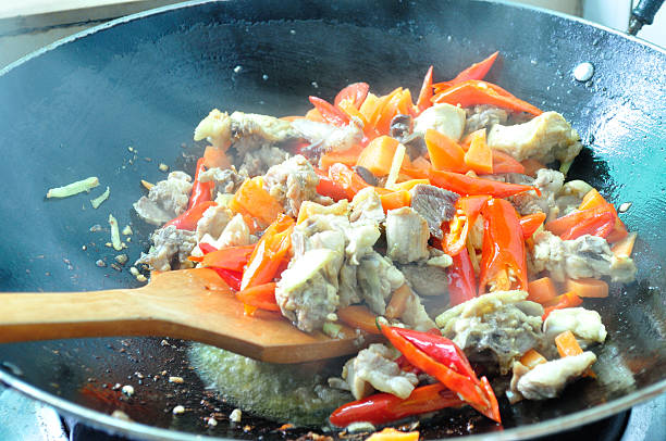 istock stir frying chicken and vegetabele in wok 469767899