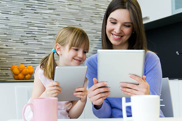 istock Mother and daughter using a digital tablet in kitchen 469768255