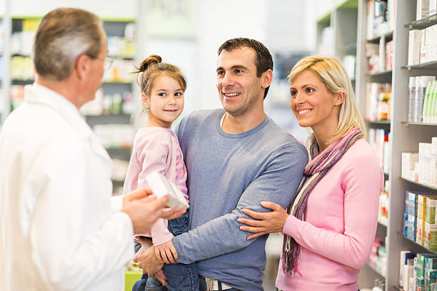 istock Family at the pharmacy talking with pharmacist. 469769278