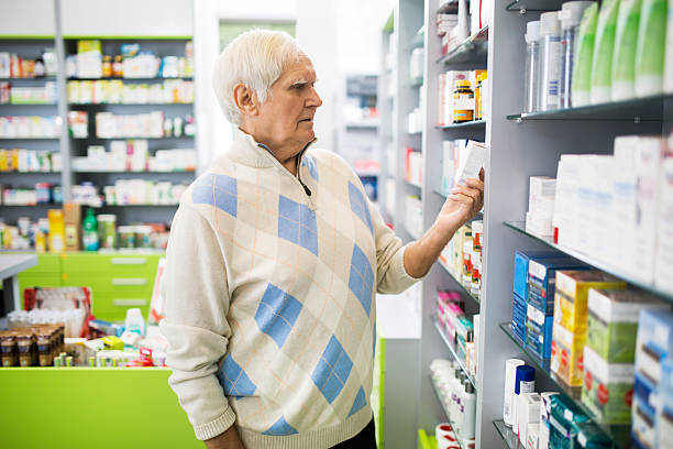 istock Senior man looking at medicine in a pharmacy. 469769390