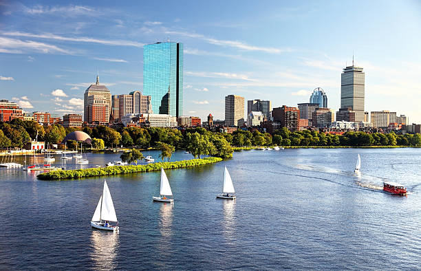 Sailing in Boston Sailboats on the Charles River with Boston's Back Bay skyline in the background. Boston is the largest city in New England, the capital of the state of Massachusetts. Boston is known for its central role in American history,world-class educational institutions, cultural facilities, and champion sports franchises. boston massachusetts photos stock pictures, royalty-free photos & images