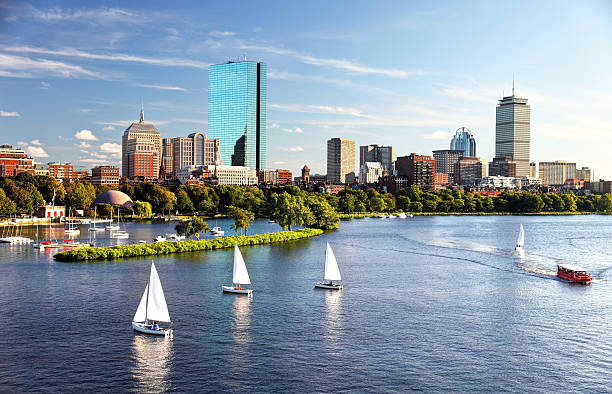 Sailing in Boston Sailboats on the Charles River with Boston's Back Bay skyline in the background. Boston is the largest city in New England, the capital of the state of Massachusetts. Boston is known for its central role in American history,world-class educational institutions, cultural facilities, and champion sports franchises. charles river stock pictures, royalty-free photos & images