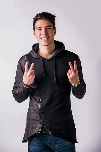 istock Attractive young man doing peace or victory sign 469769802