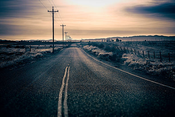 istock Rural Back Road at Dusk With Telephone Poles 469769854