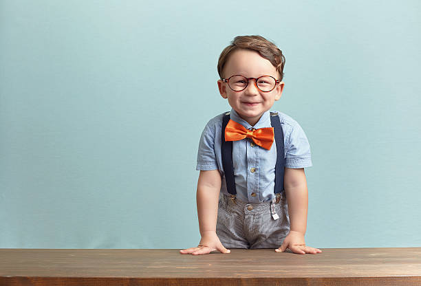 istock A smiling little boy wearing a orange bowtie and glasses 469769872